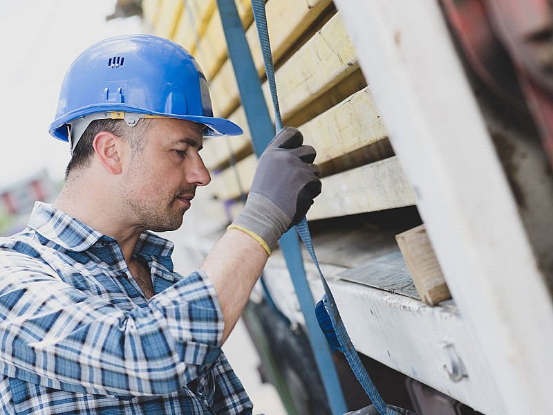 Securing lashing straps on flatbed trailer